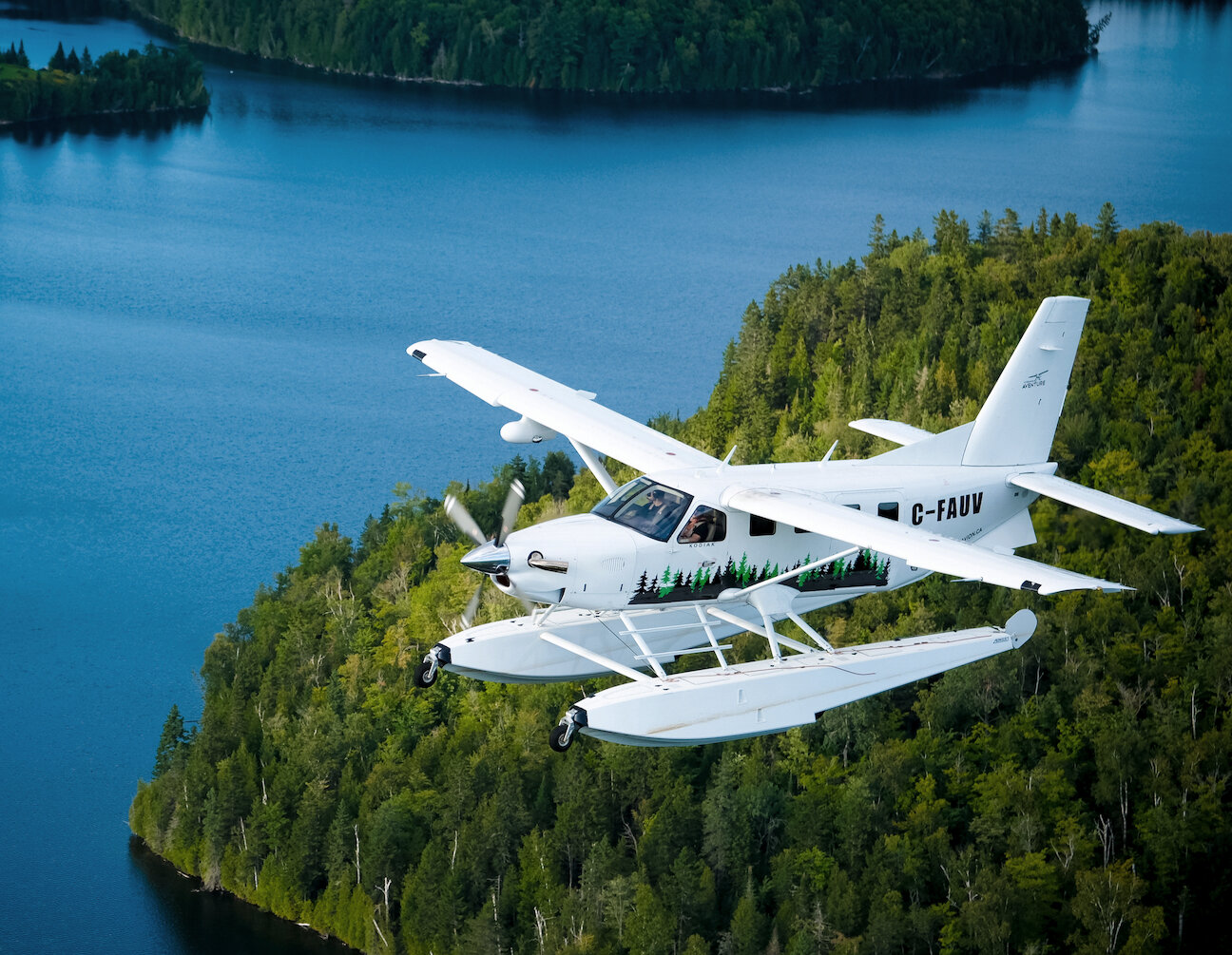 A seaplane flying over a lake