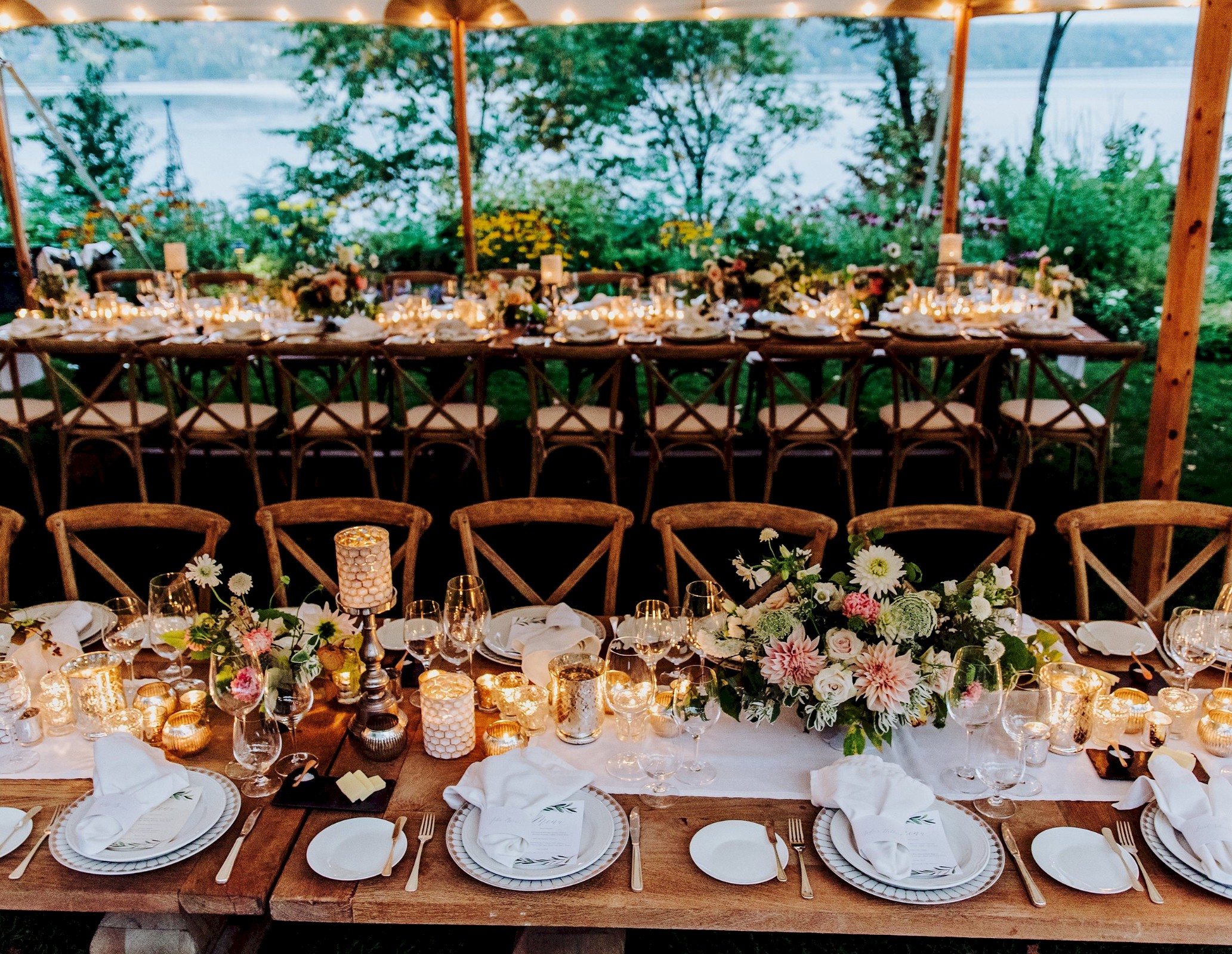 Beautifully laid tables for dinner by the lake